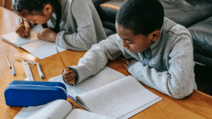 boy in school writing and reading