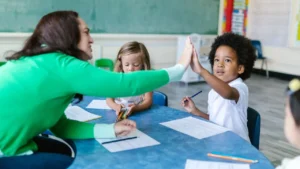 teacher giving a high five to a student