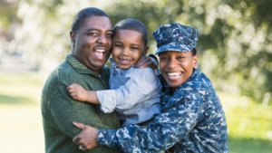 Military mother and father holding their toddler together for a family portrait.